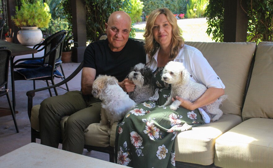 Tom and Dana Saputo sit in their backyard with their three dogs. Tom Saputo's double-lung transplant was fully covered by insurance, but he was responsible for an $11,524.79 portion of the charge for an air ambulance ride.