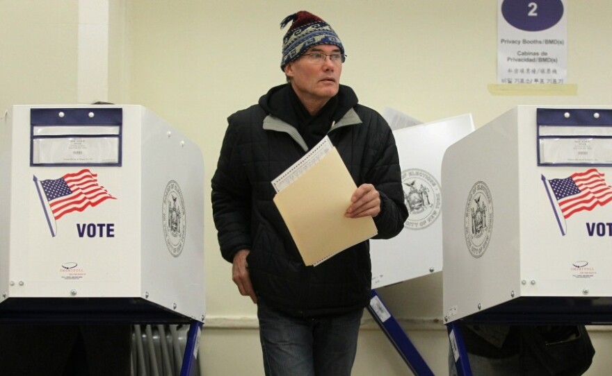 A voter walks away from a booth after marking his ballot at a Manhattan polling place on Tuesday.