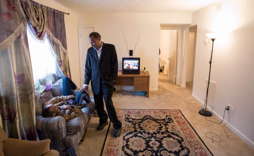 Shekhey talks with a disabled Somali who recently arrived in the United States in the apartment where the man lives with other Somali refugees. "Communities have to help each other," Shekhey says. "That's the way we build dreams."