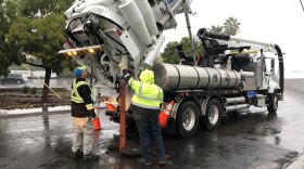 City workers pump sewers during a rainstorm in order to prevent flooding in San Diego, Dec. 4, 2019. 