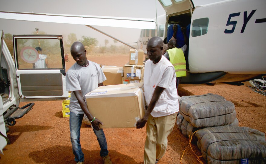 Doctors Without Borders hospital staff unload supplies from one of their planes at the Bentiu airport. All of the hospital supplies, including fuel for the generator, are flown in because South Sudan's roads are unpassable because they're in disrepair or because of the ongoing civil war.