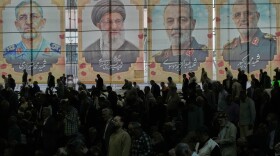 Iranian worshippers perform their Friday prayers under the portraits of the late Iranian Supreme Leader Ayatollah Ali Khamenei, second left, and top military officials who were killed during the U.S.-Israel campaign, at the Tehran University campus, in Tehran, Iran, Friday, April 24, 2026.