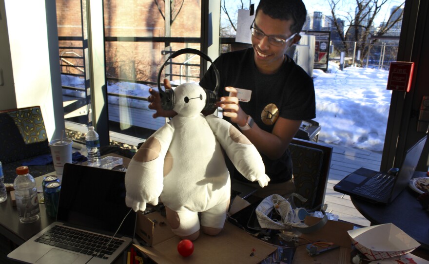 Ammar Al-Kahfah plays with a stuffed "Baymax" toy at the Georgetown Hackathon in Washington, D.C. His team has wired it to move and to collect basic medical information.