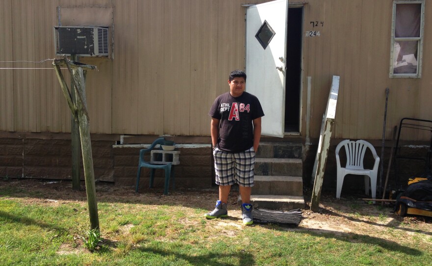 Eddie Ramirez, 15, outside his mobile home in Snow Hill, N.C. He's been working in tobacco fields during the summer for several years.