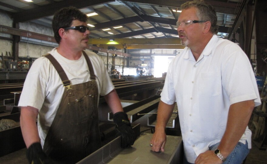 Precision Iron Works President Steve Leighton (right) says government regulations are keeping his company from growing.