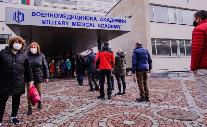 People wait in front of the hospital of the Military Medical Academy in Sofia, Bulgaria, on Feb. 21 for a COVID-19 vaccination.