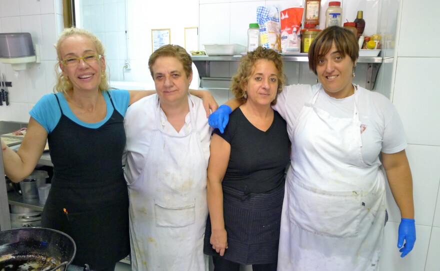 Itziar Eguileor (left), head cook at Restaurante Berrio, poses with the rest of the kitchen staff at their eatery in Galdakao, Spain. The staff used to throw away several pounds of leftover food each night, but now they haul it over to the Solidarity Fridge, Spain's first communal refrigerator, that's designed to cut down on food waste.