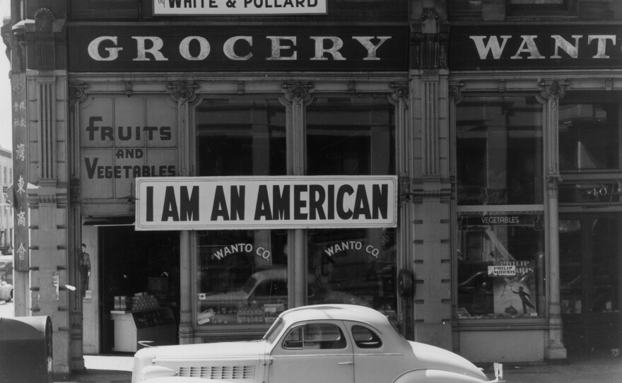 A sign reading 'I AM AN AMERICAN,' on the Wanto Co grocery store in Oakland, California on December 8, 1941, the day after the attack on Pearl Harbor. The store was closed and the Matsuda family, who owned it, was relocated and incarcerated under the US government's policy of internment of Japanese-Americans.