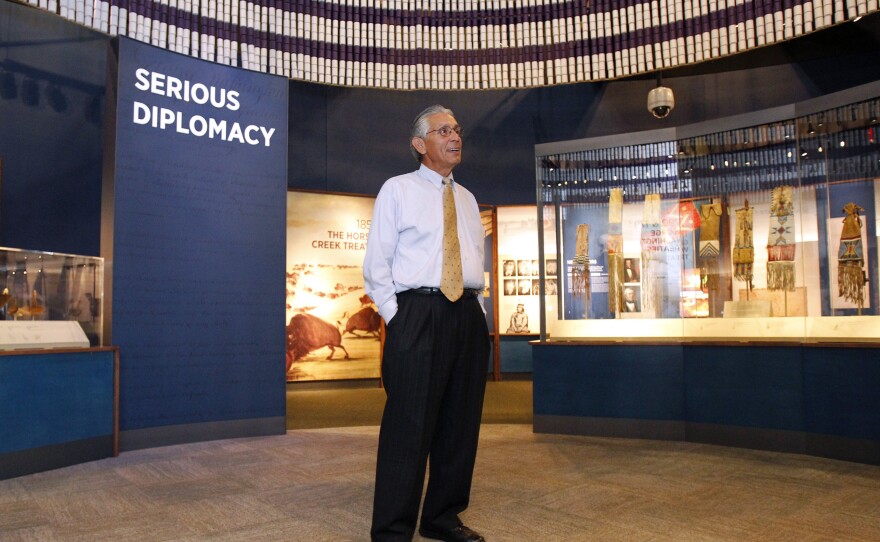 Kevin Gover, director of the National Museum of the American Indian, stands inside the "Nation to Nation" exhibit.