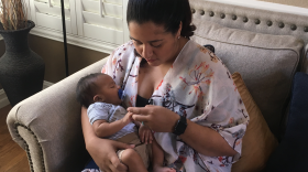 Angela George’s newborn Mateo takes a nap in her arms, July 20, 2018.