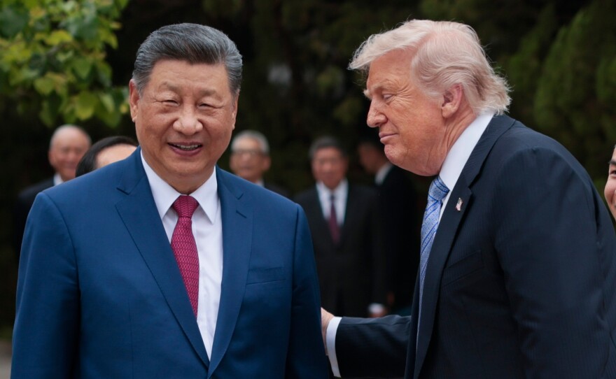 President Trump speaks with Chinese President Xi Jinping while leaving after a visit to the Zhongnanhai Garden in Beijing, May 15.