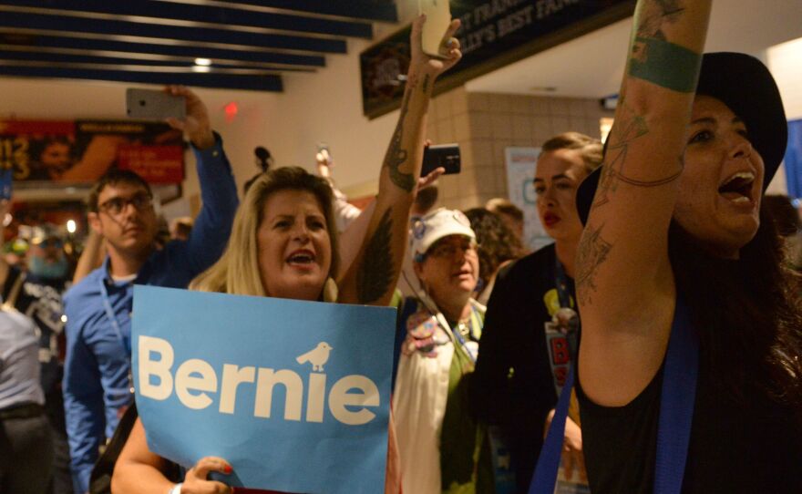 Bernie Sanders supporters walk out of the Democratic National Convention on Tuesday after Hillary Clinton became the official Democratic nominee.