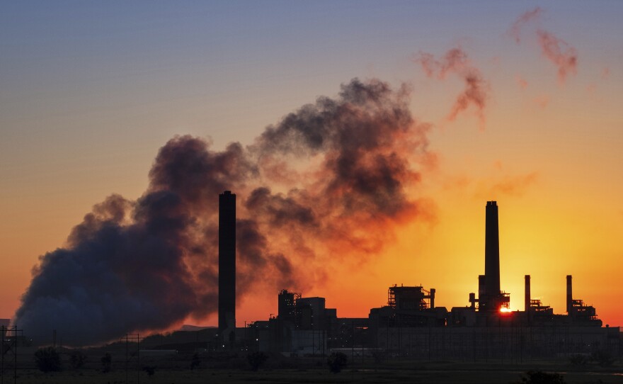 The Dave Johnson coal-fired power plant is silhouetted against the morning sun in Glenrock, Wyo., July 27, 2018. 