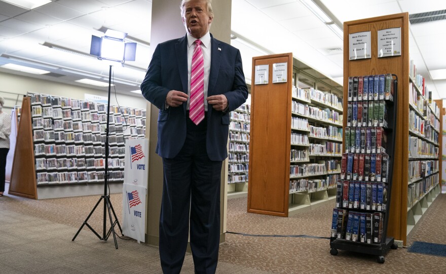 President Trump talks with reporters after casting his ballot Saturday in West Palm Beach, Fla.