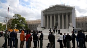 People line up to enter the Supreme Court building on April 22, when the court heard arguments in the <em>Agency for International Development v. Alliance for Open Society International</em> case.