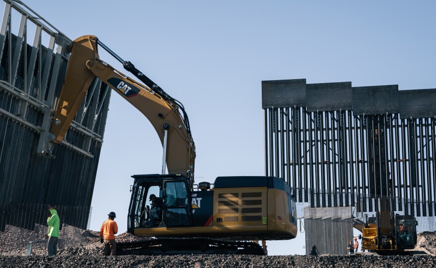 Fisher Industries workers move sections on May 24, 2019 in Sunland Park, N.M., near International Boundary Monument No. 1 where New Mexico, Texas and Mexico come together.