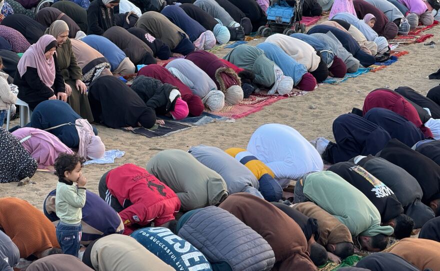 Palestinians pray in Gaza City and Eid prayers rang through the streets.