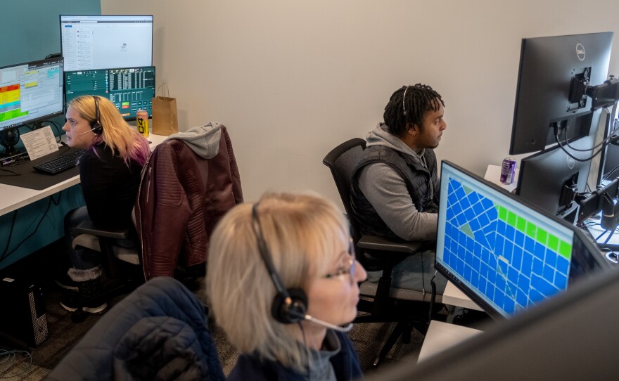 Emergency communications technicians-in-training Sarah Plopper, left, Barbara Niedt, center, and Kenneth James respond to calls during a training session at Denver 911.