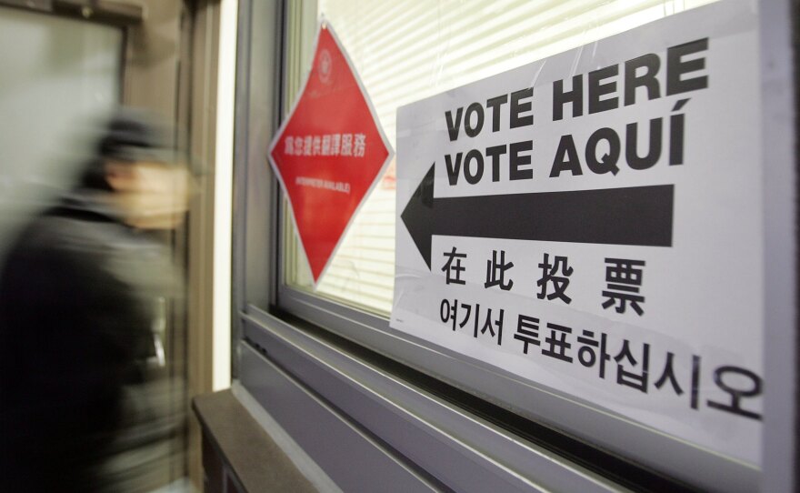 A voter enters a polling place with multilingual instructions in New York City's Chinatown in 2006. Analysts have described the Asian-American political evolution as one of the most dramatic swings in recent presidential voting behavior across any demographic.