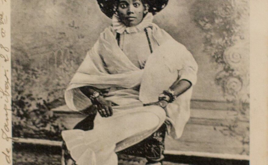 <em>An Arab Turban Lady, Zanzibar</em> by A.C. Gomes & Son. Photograph taken before 1900; postcard printed before 1914.