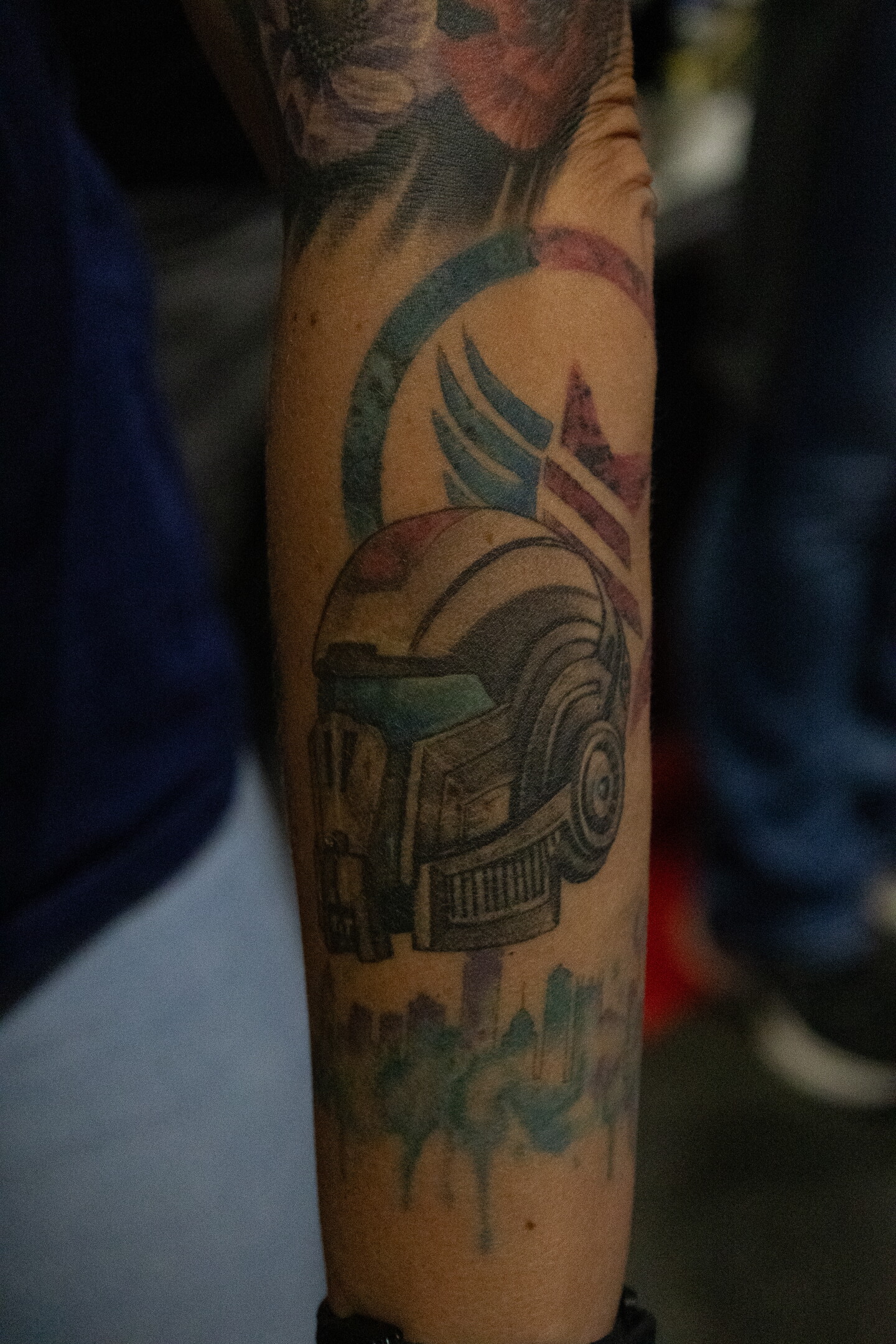 A tattoo of the Commander Shepard N7 helmet from the "Mass Effect" video game is profiled on an attendee's forearm at Comic-Con, July 23, 2026.