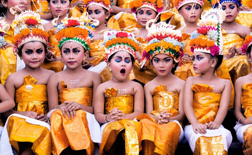A yawn from one of the girls who'll perform a traditional dance at the Hindu Melasti Festival in Bali, Indonesia.