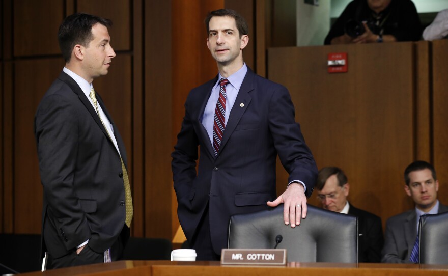 Sen. Tom Cotton, R-Ark. (right), talks with an aide before Attorney General Jeff Sessions is sworn in Tuesday.