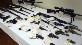 A cache of seized weapons is displayed during a press conference in Los Angeles, Calif., Tuesday, Feb. 6, 2018. 