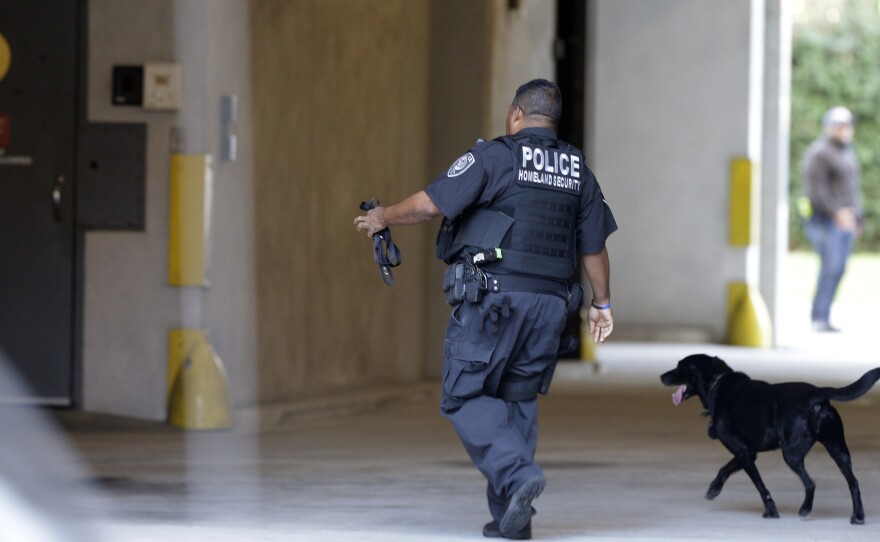 An officer with the Department of Homeland Security patrols outside the federal courthouse in Charleston, S.C., on Monday.