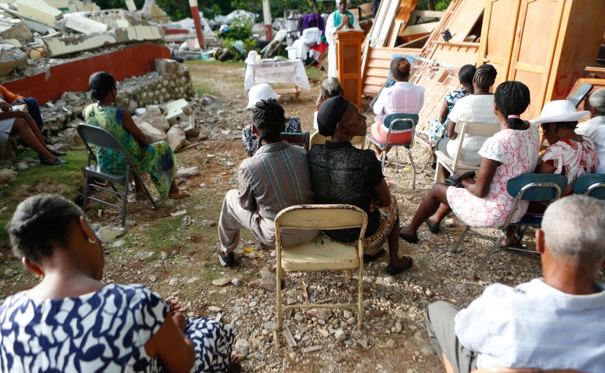 Rev. Jean Eddy Desravines, 61, of Sainte-Agnes Catholic Church near Les Cayes, Haiti, celebrates Mass on Sunday. The church sanctuary was destroyed in the 7.2 magnitude earthquake that struck earlier this month.