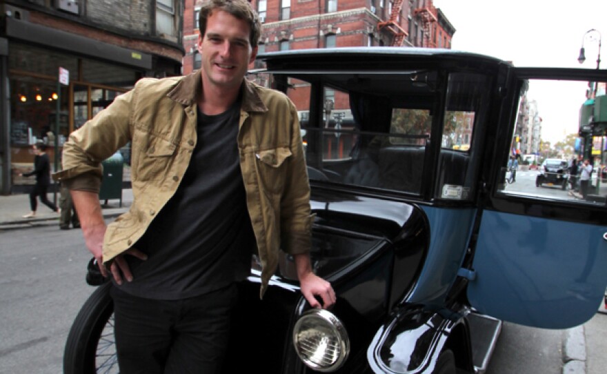 Host Dan Snow standing next to vintage Ford Model-T car.