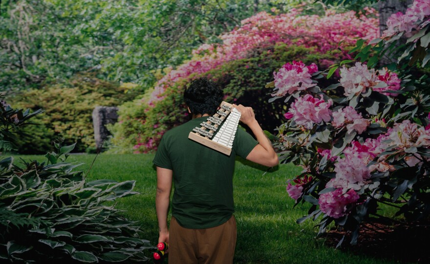 A Northern Virginia Juvenile Detention Center resident holds a marimba after his final performance as part of Sound Impact's "Use Your Voice" residency.