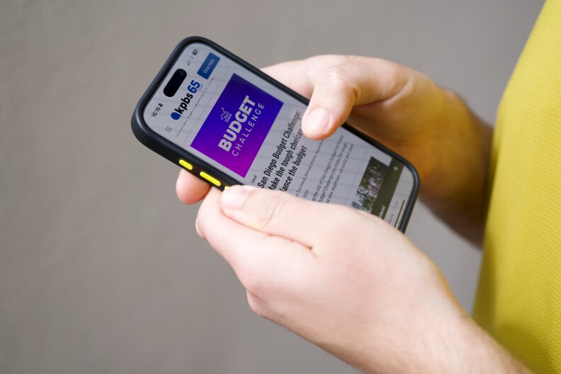 A person plays the KPBS Budget Challenge on June 10, 2025. 