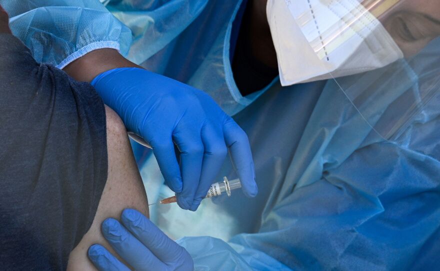 A flu vaccine is administered at a walk-up COVID-19 testing site, in San Fernando, Calif. Emergency use authorization is expected soon for vaccines for COVID-19.