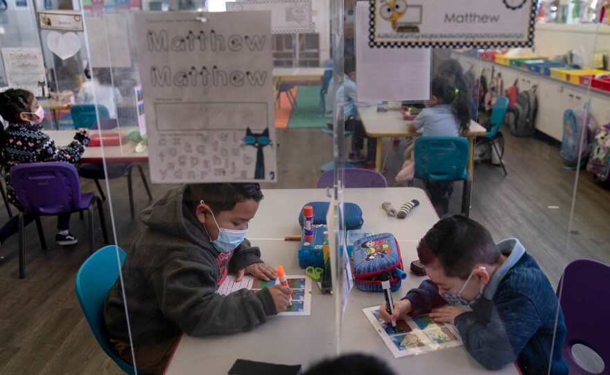 Pre-kindergarten students work on their school work at West Orange Elementary School in Orange, Calif. The Centers for Disease Control and Prevention relaxed its social distancing guidelines for schools on March 19, saying students can now sit 3 feet apart in classrooms.