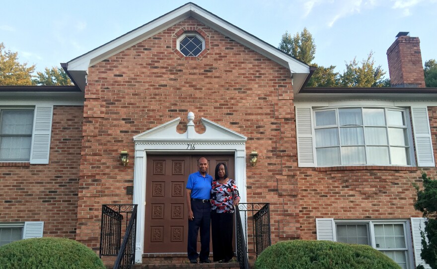 Grattan (left) and Evelyn Betancourt stand in front of their home in Fort Washington, Md., in one of the wealthiest majority-black counties in the United States: Prince George's, just east of Washington, D.C. But the reality, Grattan says, is "that many people here, even though they've lived here for many years, are fighting to save their homes" — the Betancourts among them.