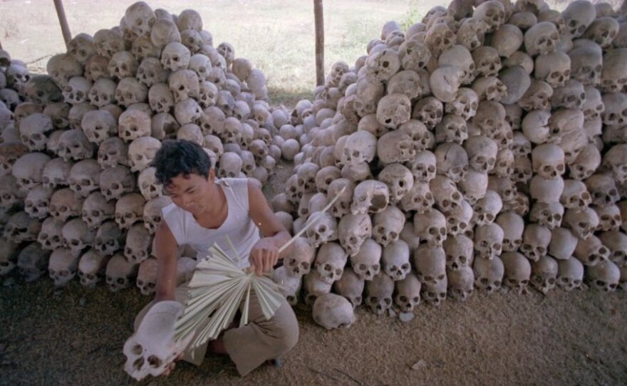 <p>In this undated photo, a man cleans a skull near a mass grave at the Choeung Ek camp outside Phnom Penh, Cambodia — the best known of the killing fields run by the Khmer Rouge in the middle and late 1970s. Now, Cambodians are skeptical that a U.N.-backed tribunal will be able to deliver justice in the case of four remaining high-level Khmer Rouge officials.</p>