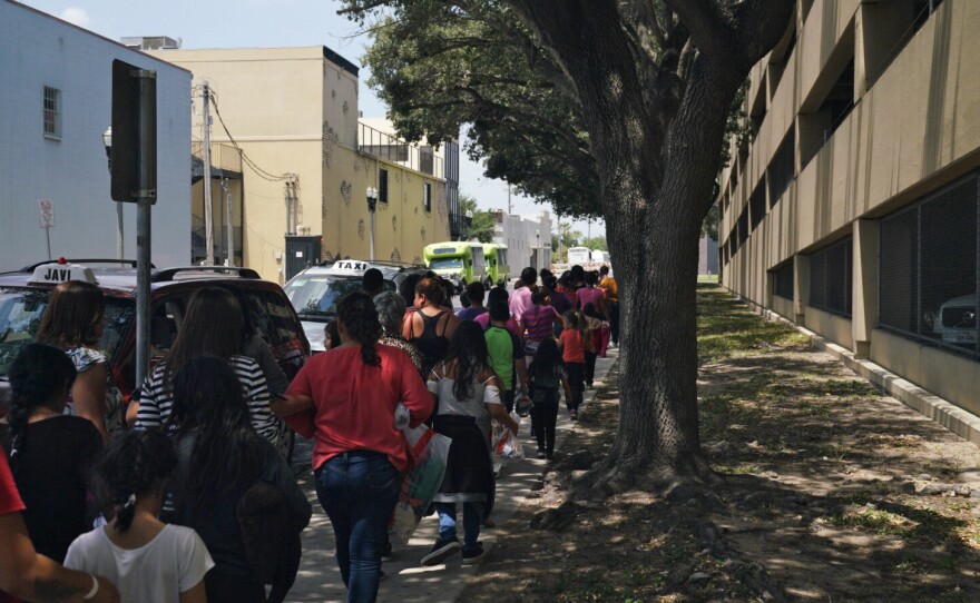 Women and children walk to a bus in McAllen, Texas. People released from immigration detention centers are often dropped off at the McAllen bus station in the Rio Grande Valley.