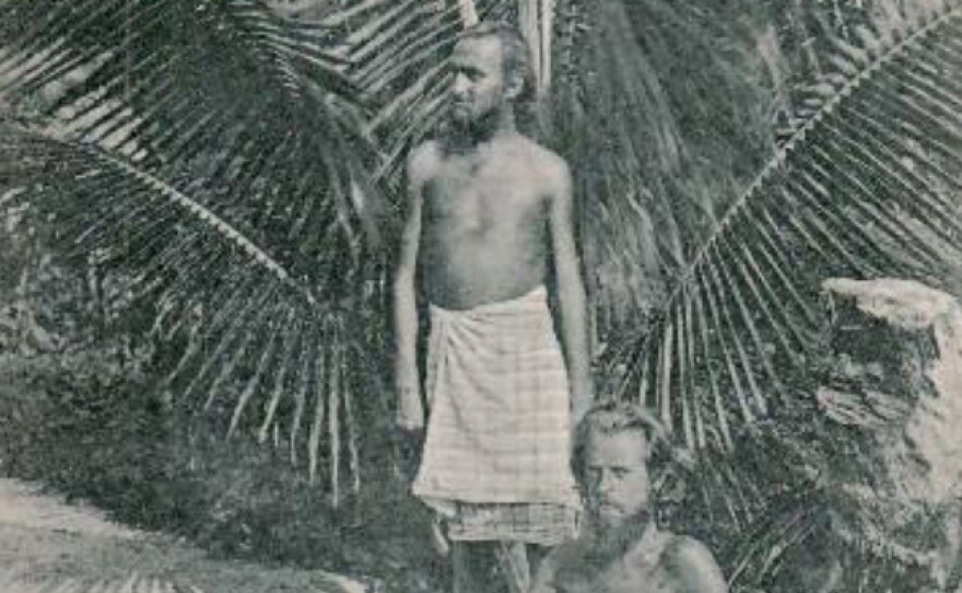 August Engelhardt stands underneath a palm tree with the Berlin concert pianist Max Lützow at his feet. Lützow went to Kabakon to join Engelhardt's sun-worshipping cocovore cult, The Order of the Sun. He died there, as did several other followers.
