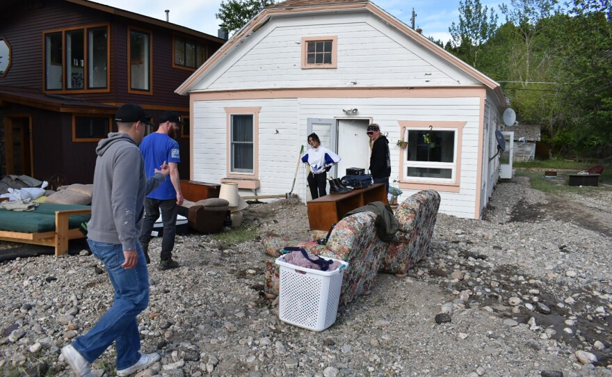 Residents of Red Lodge, Mont., inspect damage to a house that was flooded after torrential rains fell across the Yellowstone region, on Tuesday.