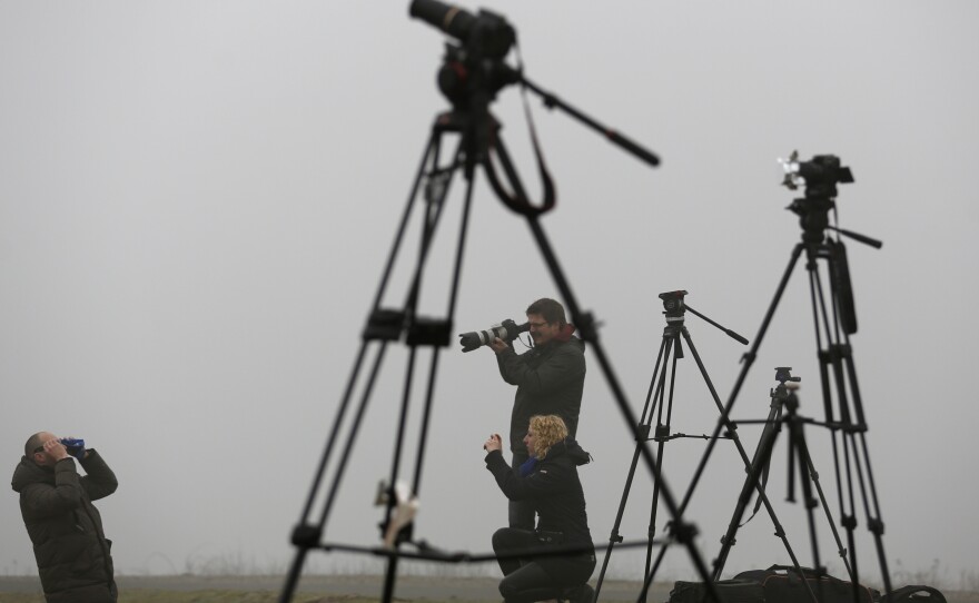 Journalists prepare to view the partial eclipse at 'Halde Hoheward' in the western city of Herten, Germany.