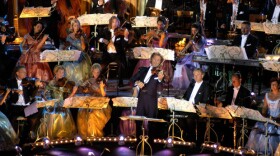 André Rieu (center playing violin) performs live in Tuscany, Italy at the Piazza Della Republica joined by the Johann Strauss Orchestra.