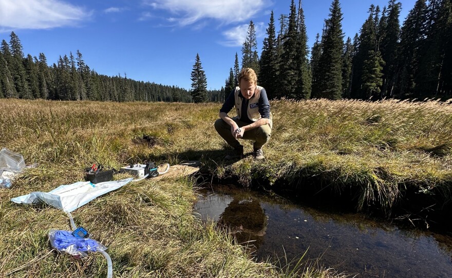 EIS officer Dr. Arran Hamlet observes a water source being tested for environmental contamination of fecal waste and norovirus.