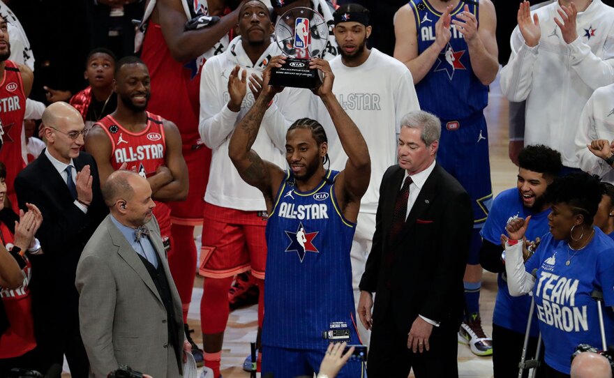 Former San Diego State star and current Los Angeles Clipper Kawhi Leonard holding up his NBA All-Star Game Kobe Bryant MVP Award after the NBA All-Star basketball game Sunday, Feb. 16, 2020, in Chicago.
