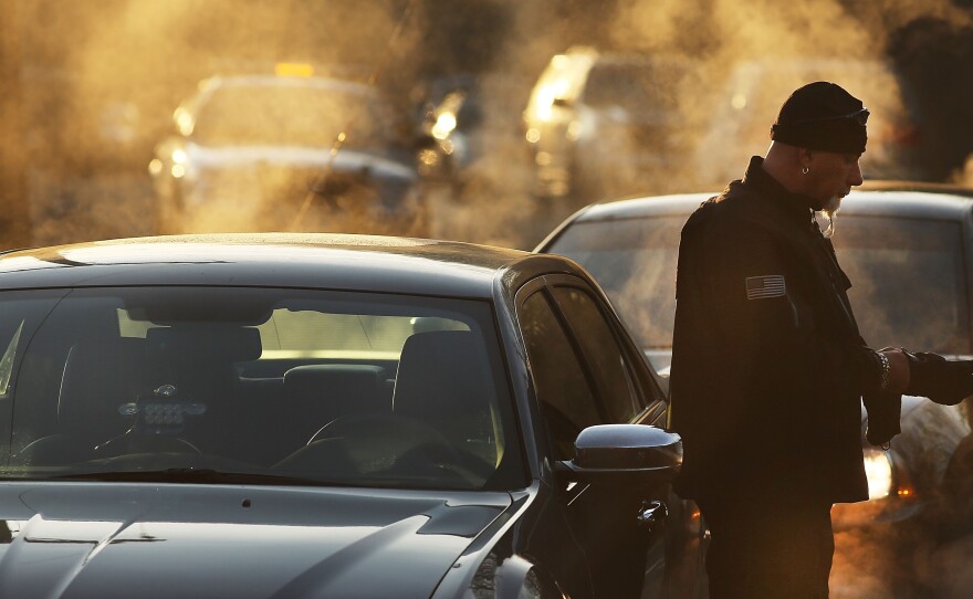 A police officer stands outside the entrance to Sandy Hook Elementary School in Newtown, Conn., on Dec. 15, 2012.