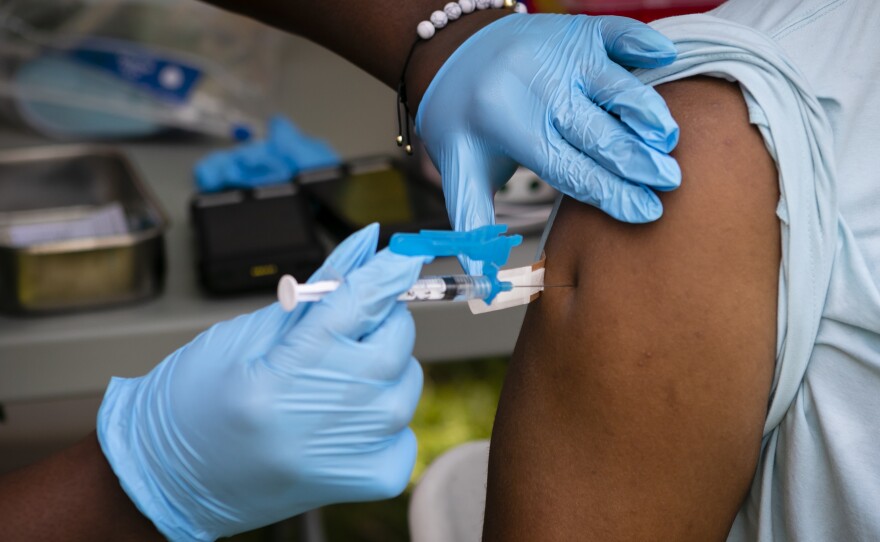 A person receives a dose of the Johnson & Johnson Covid-19 vaccine during a Miami-Dade County Homeless Trust mobile vaccination outreach event in Miami, Florida, U.S., on Thursday, May 13, 2021.