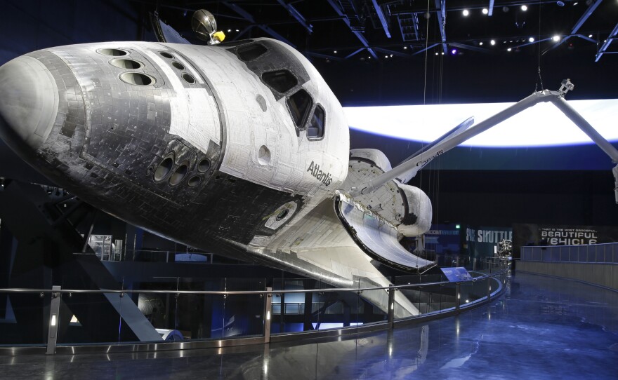 The space shuttle Atlantis, with its cargo arm extended, goes on display today the Kennedy Space Center Visitor Complex in Cape Canaveral, Fla.