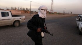 A Libyan policeman who defected to the side of anti-government protesters manned a checkpoint in the opposition-held, eastern city of Tobruk on Thursday.