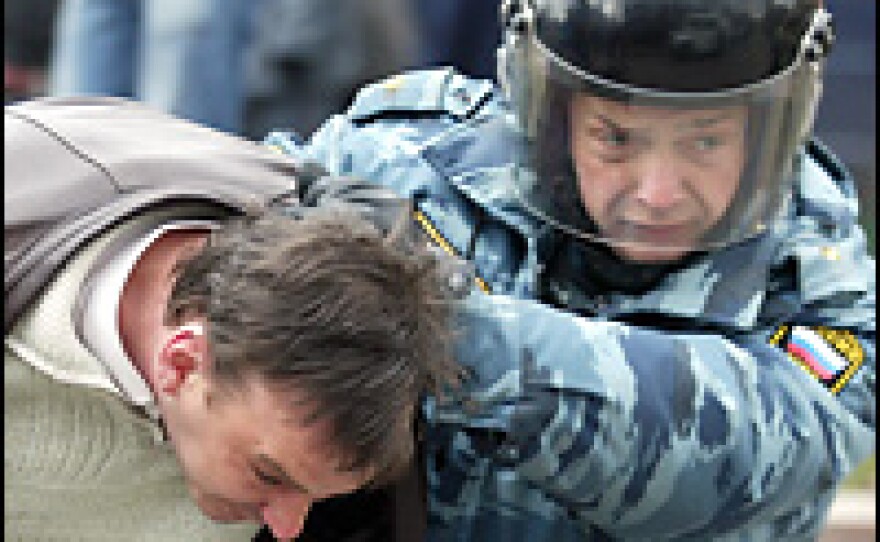 A Russian riot policeman arrests an opposition supporter during a rally in central Moscow on Saturday.