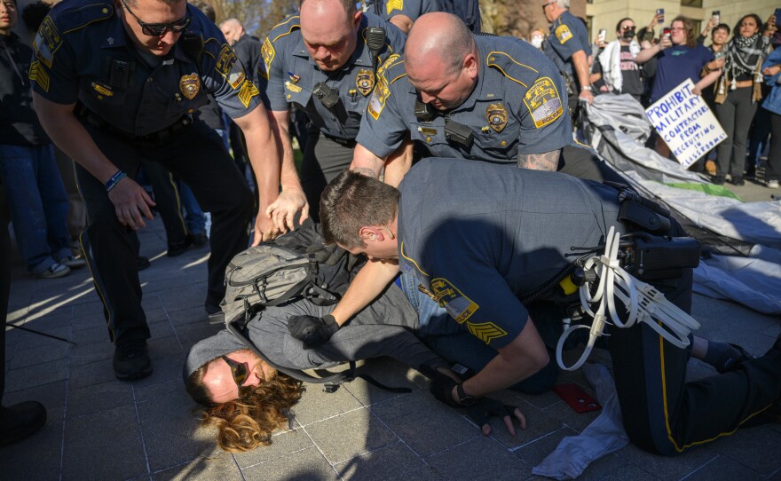A University of Connecticut student is arrested during a rally on campus calling for the university to divest from companies they say are playing a role in the Israel-Hamas war. More than 150 people attended the event April 25, 2024.